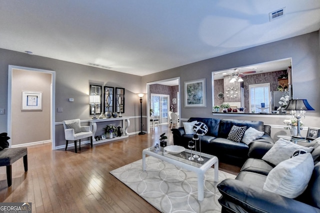 living room featuring ceiling fan and hardwood / wood-style floors