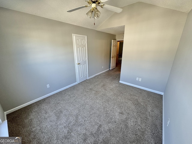 carpeted empty room with ceiling fan, a textured ceiling, and lofted ceiling