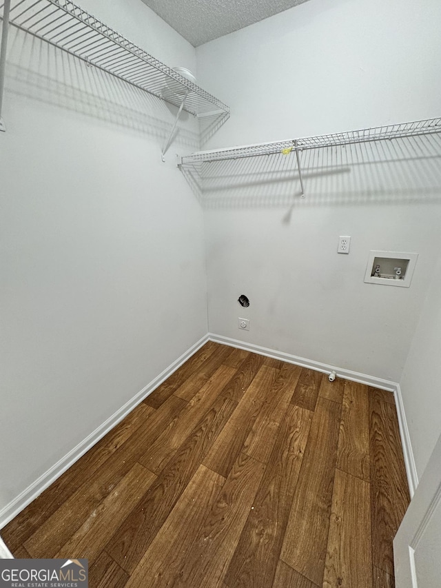 laundry area with hookup for a washing machine, hardwood / wood-style floors, a textured ceiling, and hookup for an electric dryer