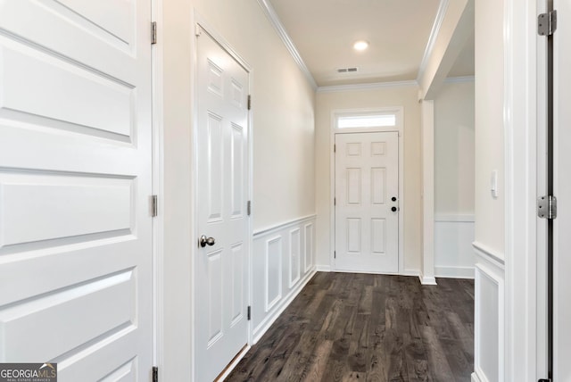 doorway to outside with crown molding and dark wood-type flooring