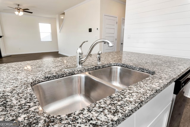 room details featuring crown molding, stone countertops, ceiling fan, sink, and dark wood-type flooring