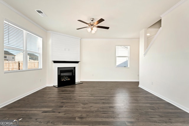 unfurnished living room featuring ceiling fan, crown molding, and dark hardwood / wood-style floors