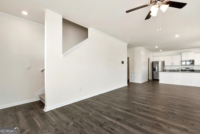 unfurnished living room featuring ceiling fan, crown molding, and dark hardwood / wood-style floors