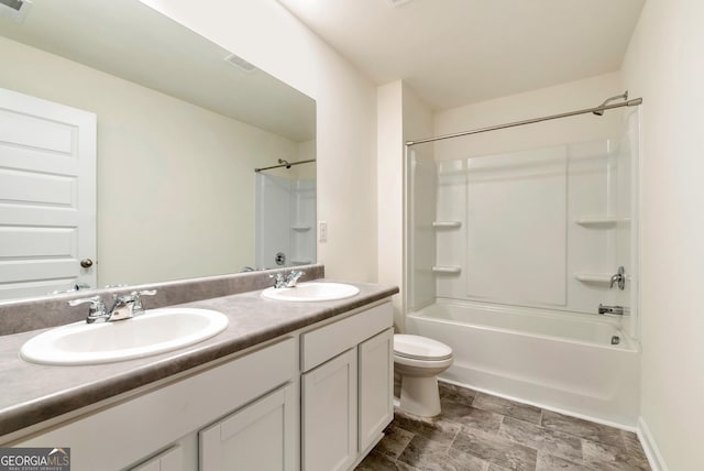 full bathroom featuring vanity, bathing tub / shower combination, and toilet