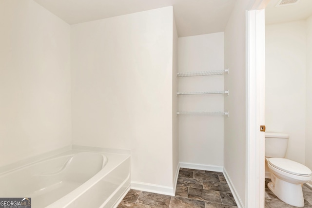 bathroom with toilet and a bathing tub