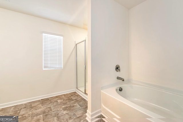 bathroom with separate shower and tub