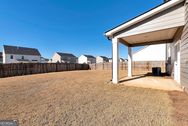 view of yard featuring a patio and central AC