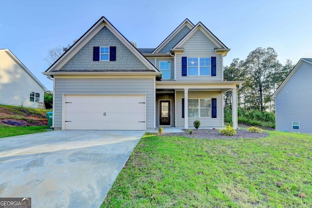 craftsman-style house featuring a garage and a front lawn