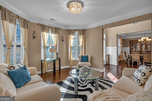 living room featuring ornamental molding, dark hardwood / wood-style floors, and an inviting chandelier