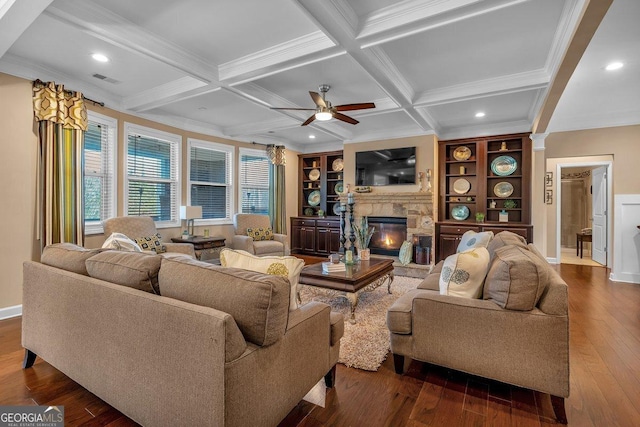 living room featuring built in features, beam ceiling, coffered ceiling, a fireplace, and dark hardwood / wood-style flooring