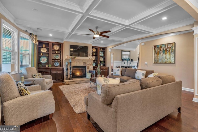 living room with built in features, beam ceiling, coffered ceiling, ornamental molding, and dark hardwood / wood-style flooring