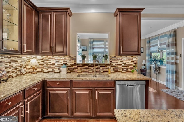 kitchen featuring tasteful backsplash, crown molding, sink, and stainless steel dishwasher