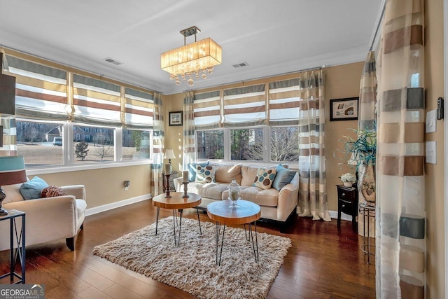 sunroom / solarium featuring a chandelier