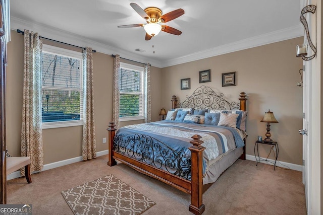 carpeted bedroom with crown molding and ceiling fan