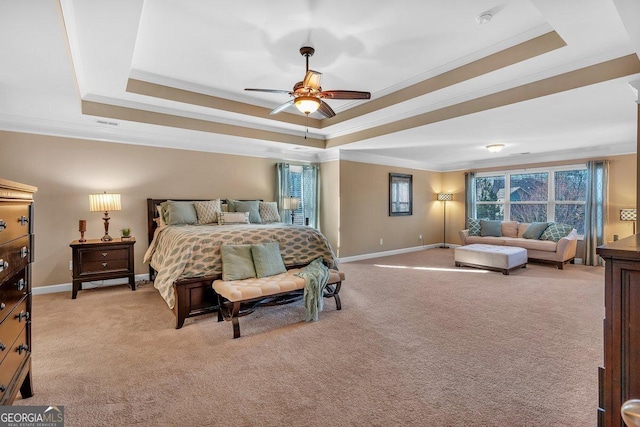 bedroom with ceiling fan, ornamental molding, and a raised ceiling