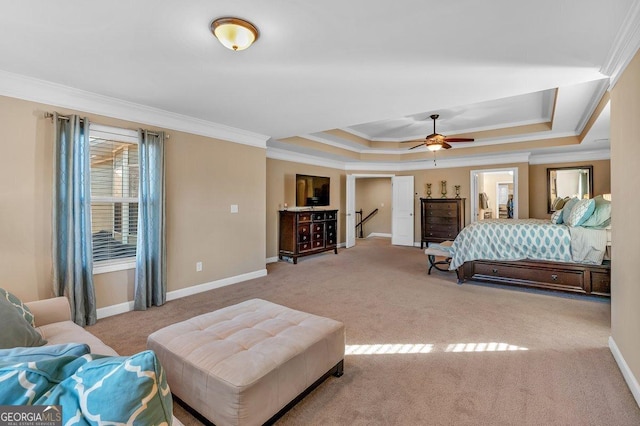 bedroom with a raised ceiling, crown molding, light colored carpet, and ceiling fan