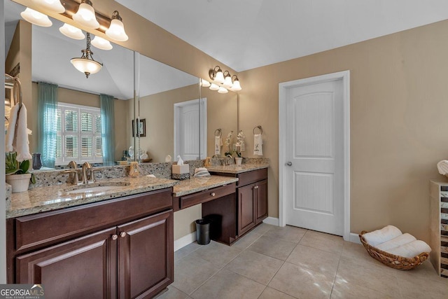 bathroom featuring lofted ceiling, tile patterned floors, and vanity