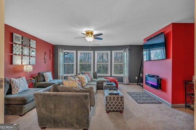 carpeted living room with ceiling fan