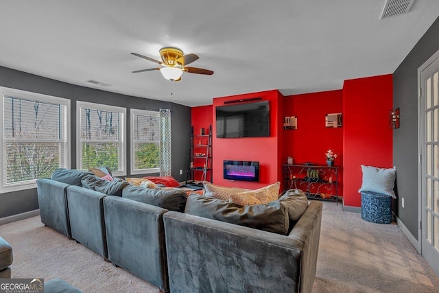 carpeted living room with ceiling fan