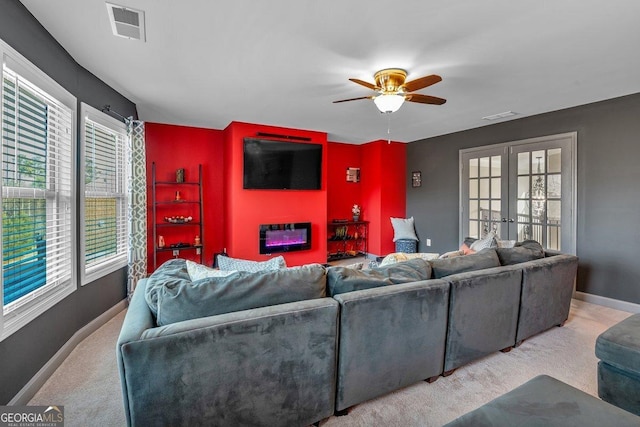 living room featuring french doors, ceiling fan, and light carpet