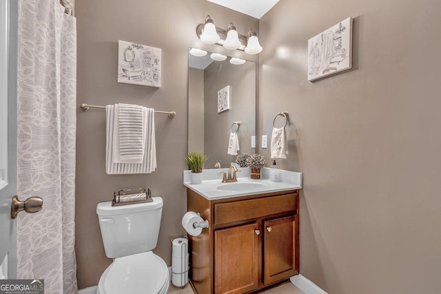 bathroom featuring vanity and toilet