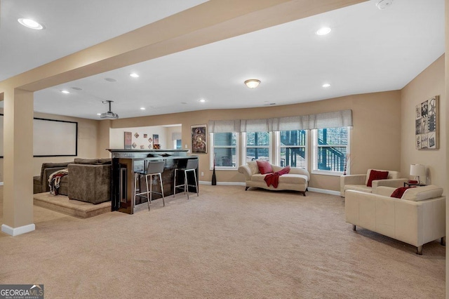 living room featuring light colored carpet and indoor bar