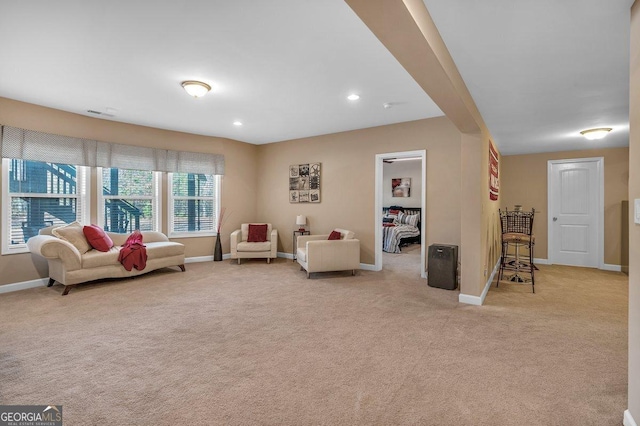 living area with light colored carpet