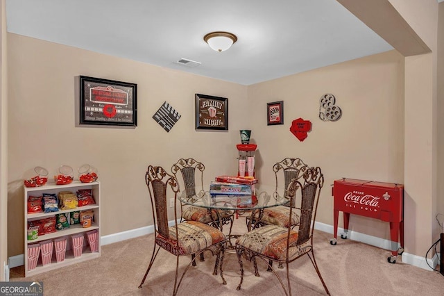 dining space with light colored carpet