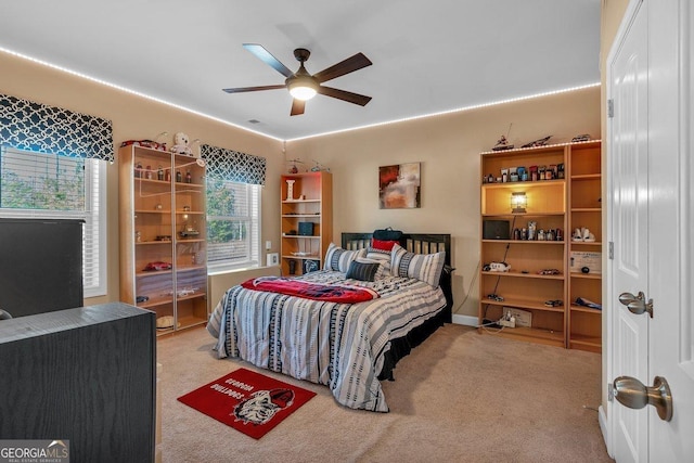 bedroom featuring ceiling fan and light carpet