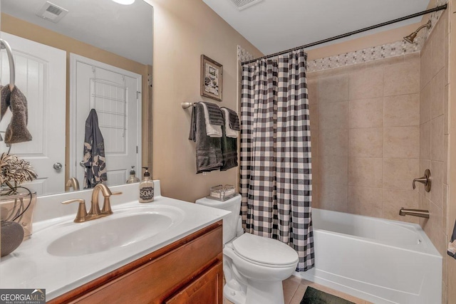 full bathroom with vanity, toilet, tile patterned flooring, and shower / tub combo