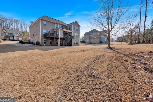 back of property featuring a yard and a deck