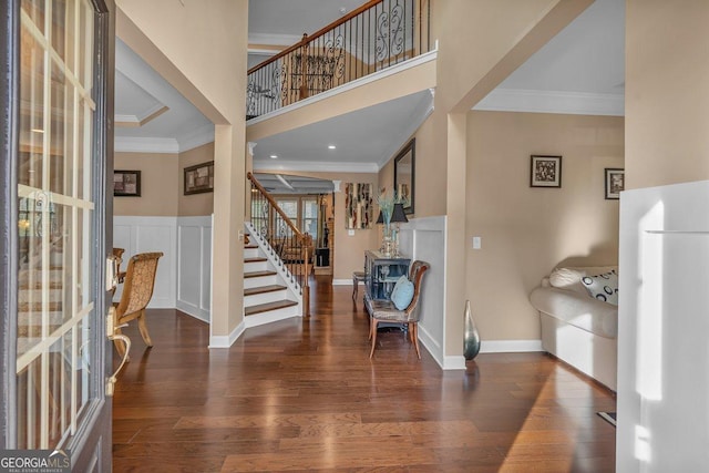 entrance foyer featuring ornamental molding and dark hardwood / wood-style floors