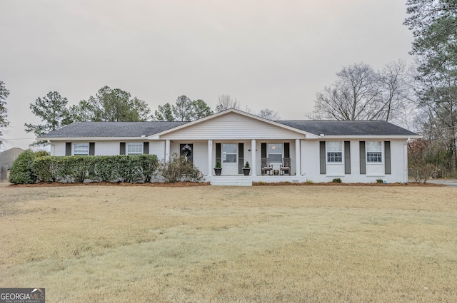 single story home with a front yard and a porch