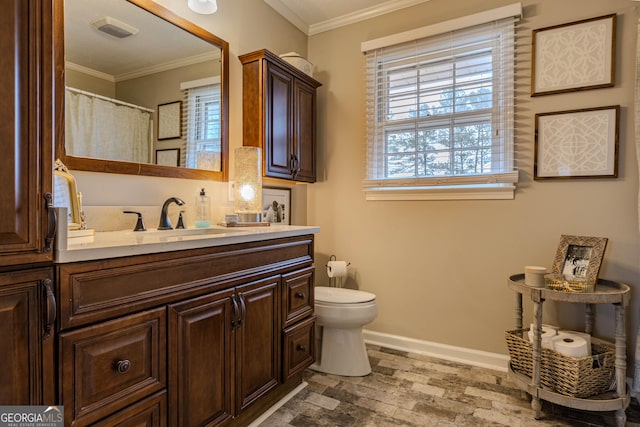 bathroom with crown molding, toilet, and vanity