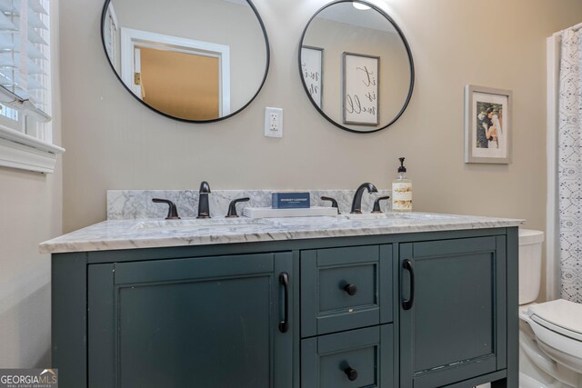 bathroom featuring toilet and vanity