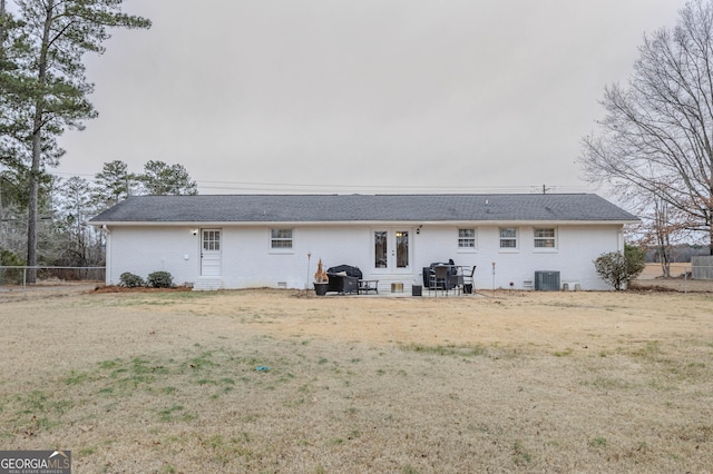 back of house featuring a yard and central AC