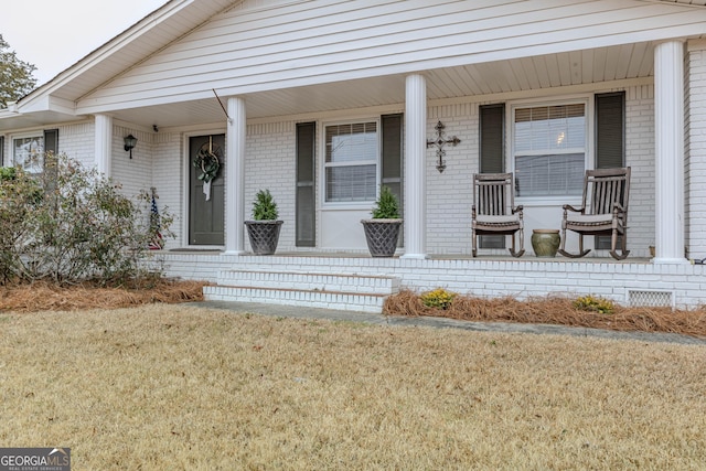 property entrance featuring a lawn