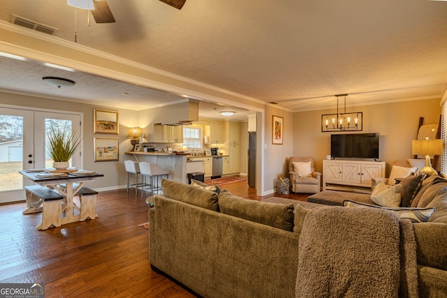 living room featuring sink, a textured ceiling, dark hardwood / wood-style floors, and crown molding