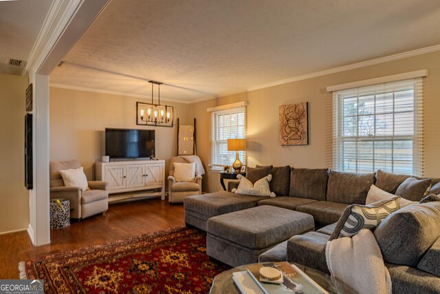 living room with a wealth of natural light, dark hardwood / wood-style flooring, and crown molding