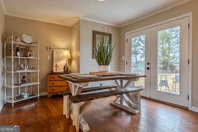 dining space with french doors, crown molding, dark hardwood / wood-style floors, and a textured ceiling