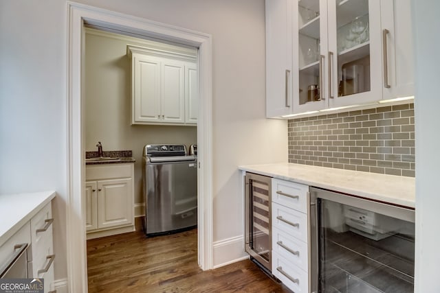 kitchen featuring sink, white cabinetry, and wine cooler