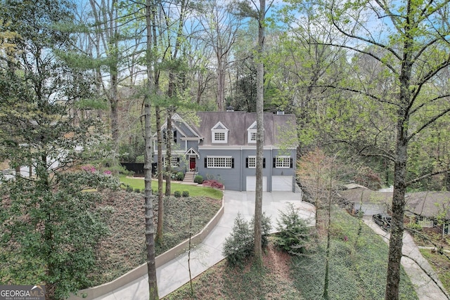 cape cod home featuring a garage