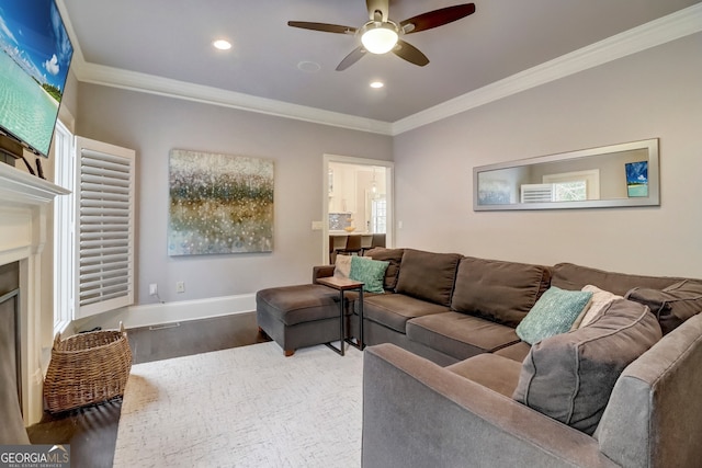 living room featuring hardwood / wood-style flooring, ceiling fan, and ornamental molding