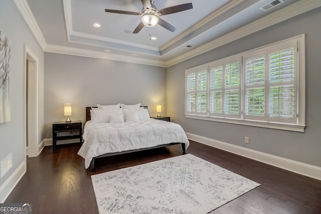 bedroom with ceiling fan, crown molding, dark hardwood / wood-style floors, and a raised ceiling