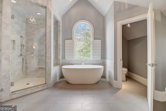 bathroom with plus walk in shower, toilet, tile patterned floors, and lofted ceiling