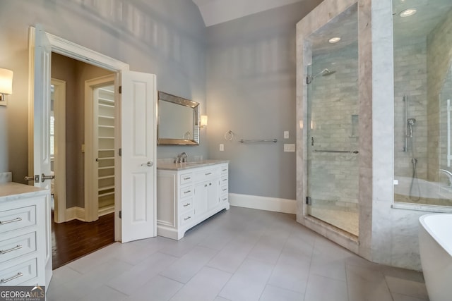 bathroom with vanity, tile patterned flooring, lofted ceiling, and plus walk in shower