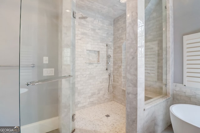 bathroom with shower with separate bathtub