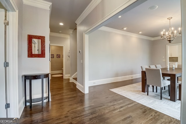 dining space featuring crown molding, dark hardwood / wood-style floors, and a notable chandelier