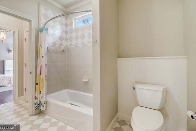 bathroom featuring toilet, ornamental molding, and shower / bath combo