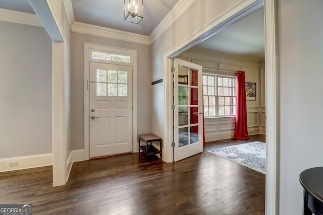 doorway to outside featuring ornamental molding, dark hardwood / wood-style floors, and an inviting chandelier